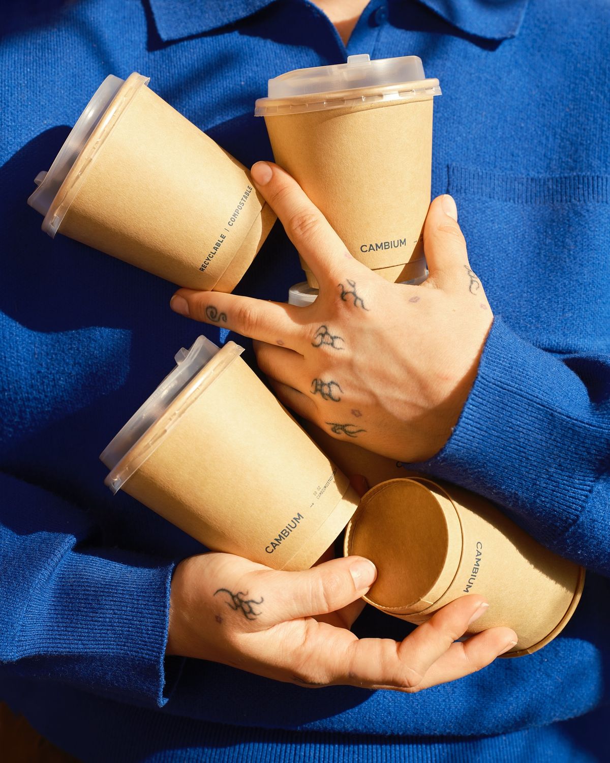 Branded cups held against a blue knit